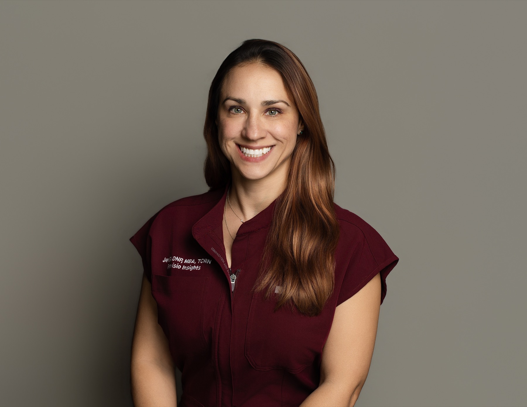 Dr. JenSU portrait in a burgundy clinical vest