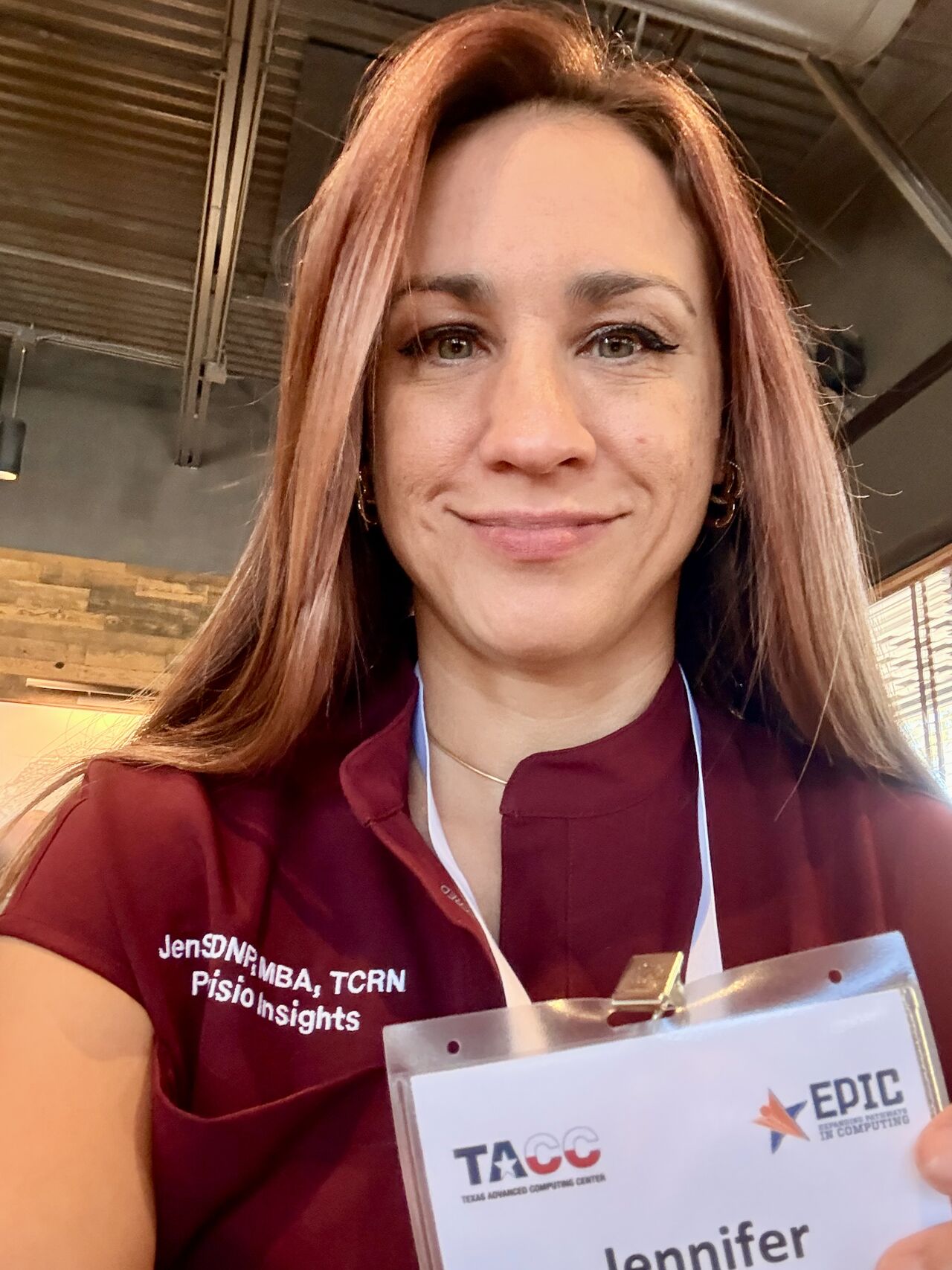 Dr. JenSU wearing a TACC and EPIC badge